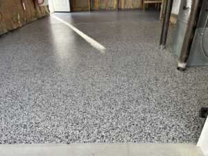 A newly installed speckled epoxy garage floor, a handyman service provided by Randy Overacre Painting Company in Virginia Beach, VA.