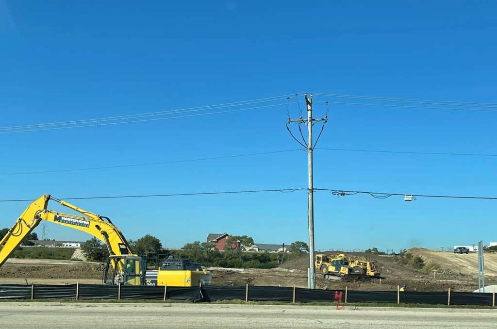 An excavator and bulldozer working on a construction site, handled by R A Seaton Contractor Services in Rockford, IL.
