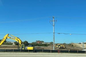 An excavator and bulldozer working on a construction site, handled by R A Seaton Contractor Services in Rockford, IL.