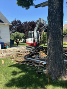 An excavator working on a demolition site for a renovation project by MRT Renovations, LLC in Oshkosh, WI