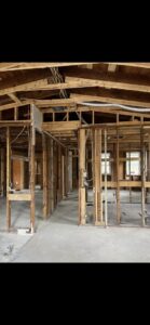 An excavator digging a large hole for site preparation by Port City Remove and Improve in Wilmington, NC