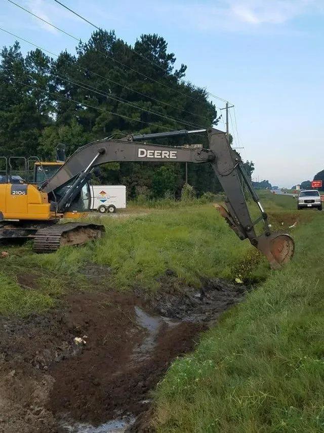 A large excavator performing environmental cleanup and excavation work for Environmental & Hazmat Services in Ashford, AL.