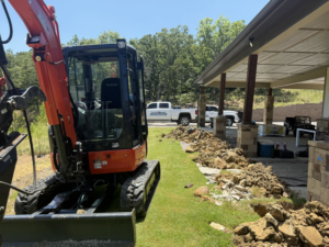 An excavator on a job site for Level Home Foundation Repair in Tulsa, OK, preparing for foundation work.