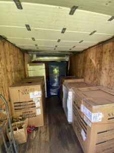 An excavator performing greenwaste removal, clearing large logs and debris, a service provided by EZ Pickups Hawaii LLC in Hilo, HI.