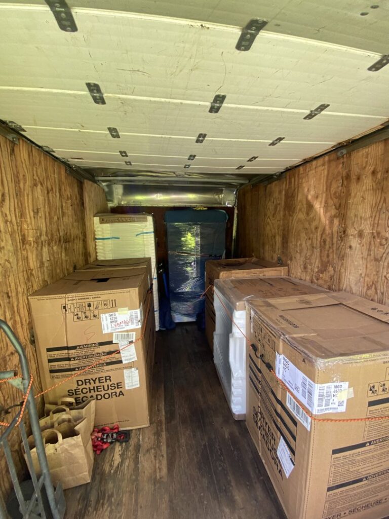 An excavator performing greenwaste removal, clearing large logs and debris, a service provided by EZ Pickups Hawaii LLC in Hilo, HI.