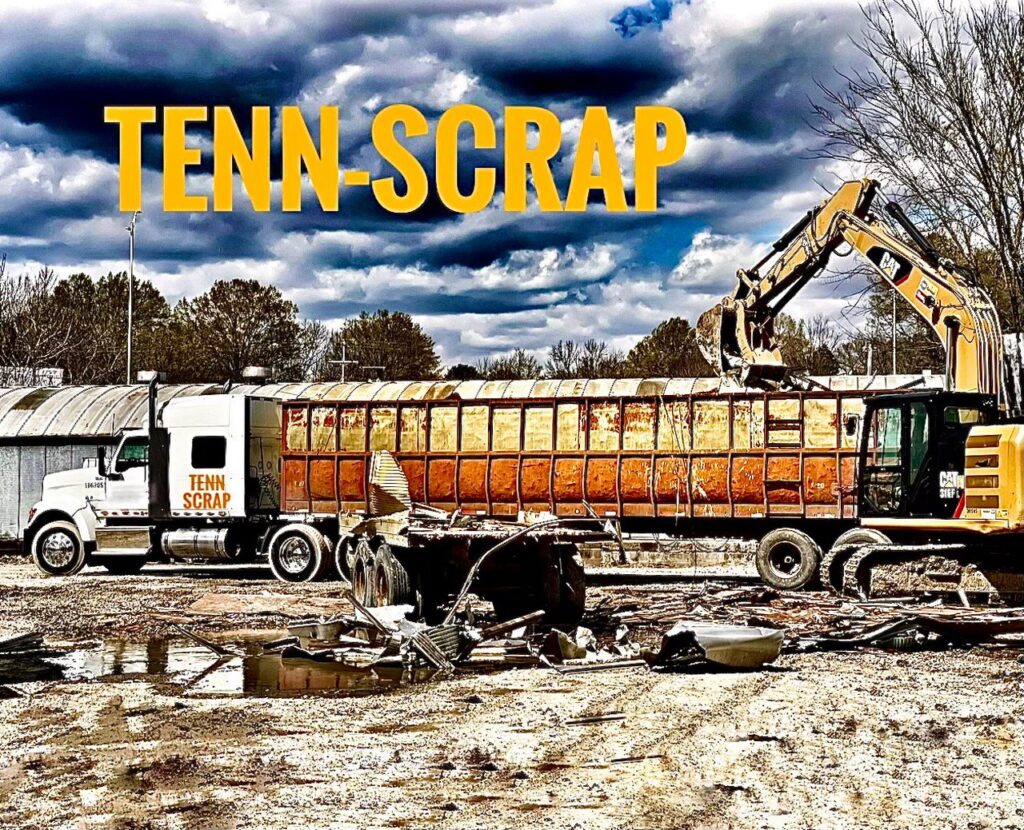 An excavator loading scrap metal into a Tenn-Scrap branded semi-trailer for transport in Jackson, TN.