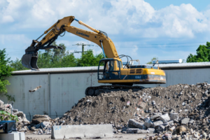 An excavator moving construction and demolition debris at Global Recycling of Tampa Bay in Tampa, FL.