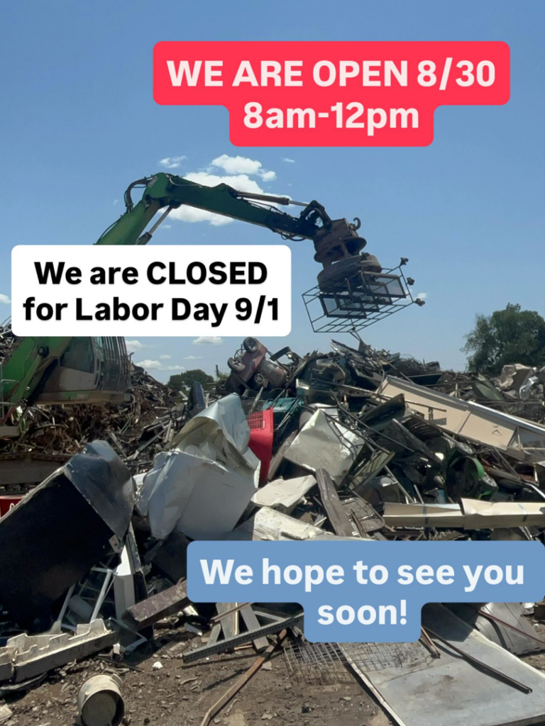 An excavator moving a large pile of scrap metal at Great Northwest Recycling in San Antonio, TX
