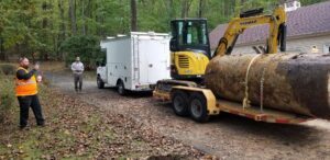 An excavator removing a large tank, demonstrating a junk removal job by All American Alloys and Recycling Inc. in Elizabeth, NJ.
