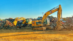 Large excavators moving and processing scrap metal at the Tenn-Scrap yard in Jackson, TN.