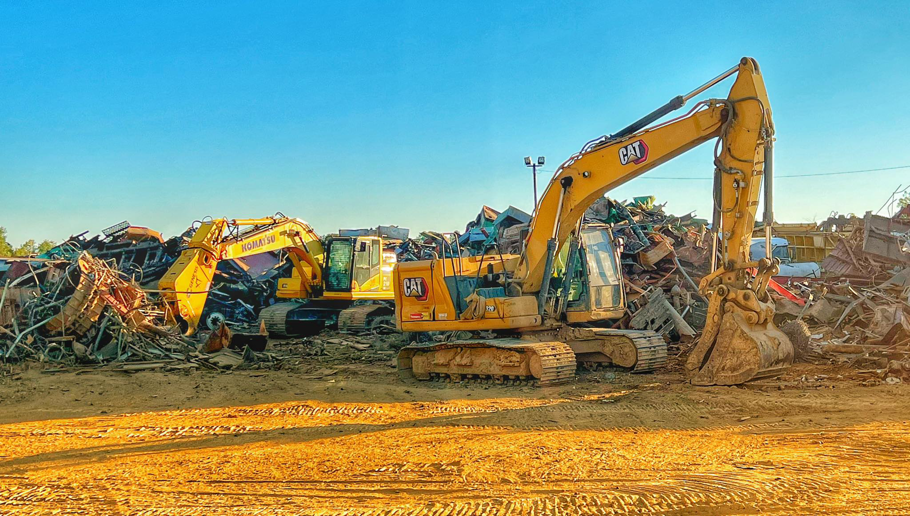 Large excavators moving and processing scrap metal at the Tenn-Scrap yard in Jackson, TN.