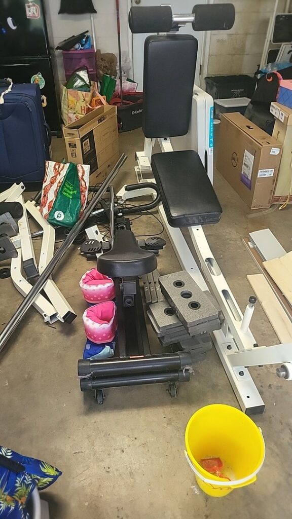 Exercise equipment and various items in a cluttered garage, awaiting junk removal by Dump My Junk LLC Demolition & Dumpster Rental in Tampa, FL.