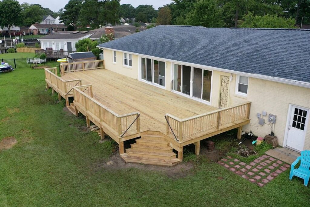 An expansive wooden deck with sturdy railings and steps, built by Dutch Deck and Fence in Norfolk, VA.