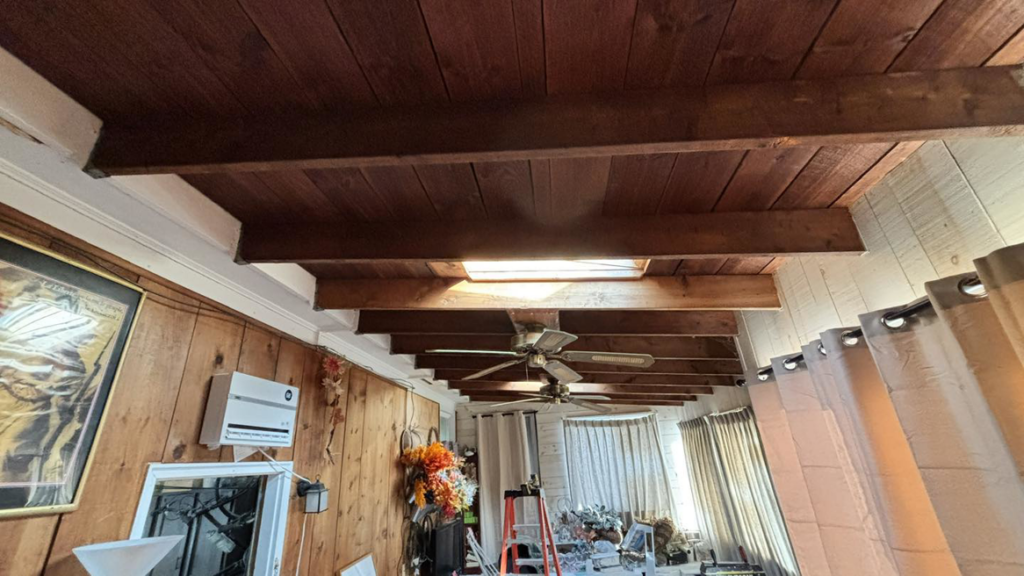 An exposed beam ceiling renovation with a ladder, showcasing handyman services by Build Brothers in Providence, RI