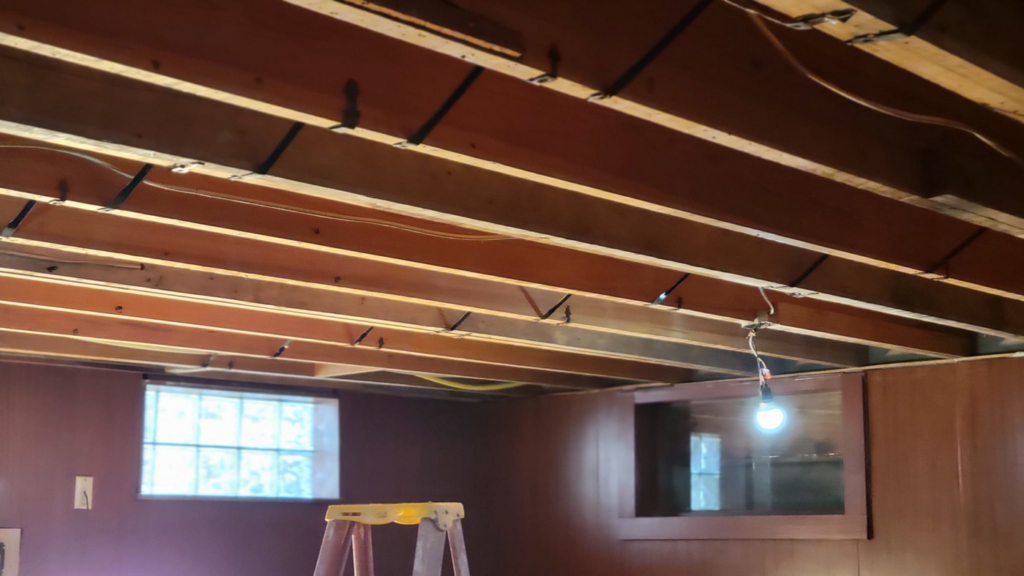 Exposed ceiling joists and wiring during a renovation project by M&M Drywall and Construction in Enid, OK