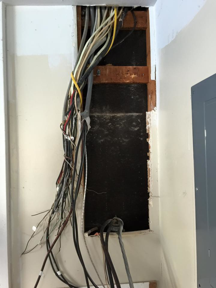 Exposed electrical wiring in a wall cavity during an installation by Econ Electrical, LLC in North Chesterfield, VA.