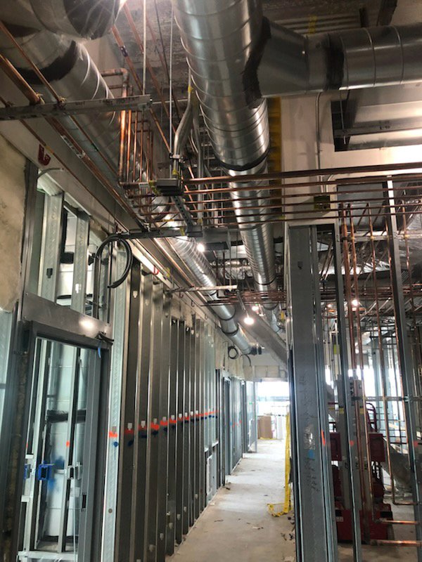 Exposed HVAC ducts and copper piping installation in a commercial building by Gorman-Lavelle Corp in Cleveland, OH