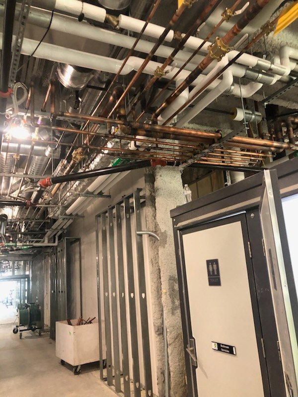 Exposed pipes and structural elements during a construction project by Gorman-Lavelle Corp in Cleveland, OH