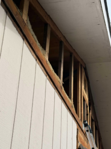 Exposed wall framing and insulation during a repair or renovation project by CJ Hansen Construction in North Bend, OR.
