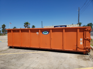 An empty Express Waste orange roll-off dumpster available for rent in Denham Springs, LA.