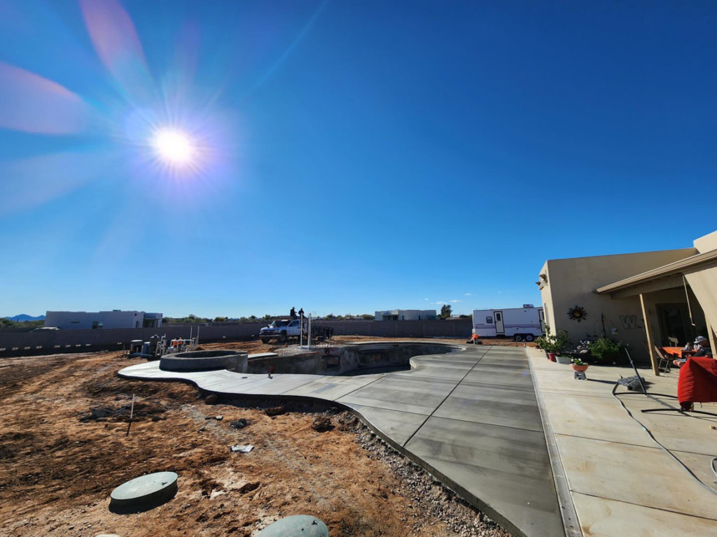 Extensive concrete pool deck and pathways installed in a backyard by Martin Jr's concrete in Surprise, AZ