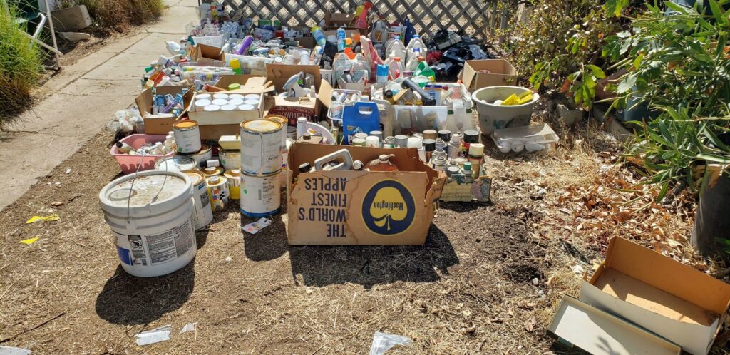 An extensive collection of various hazardous waste materials spread out for removal by Hazawaytoday.com in El Segundo, CA