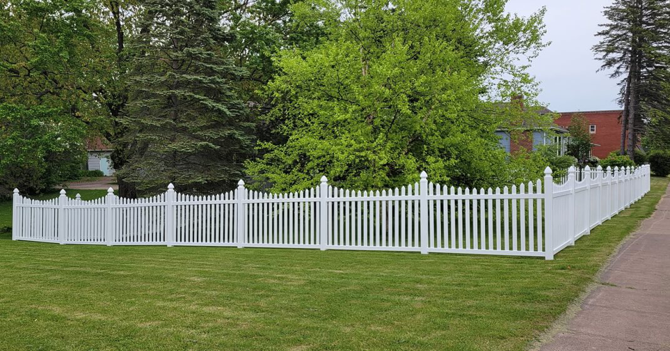 An extensive white picket fence installation showcasing craftsmanship by Cyclone Fence in Somerset, WI.