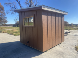 Exterior of a completed brown tiny home or sauna with a window and metal roof by No Boundaries Tiny Homes in Eau Claire, WI
