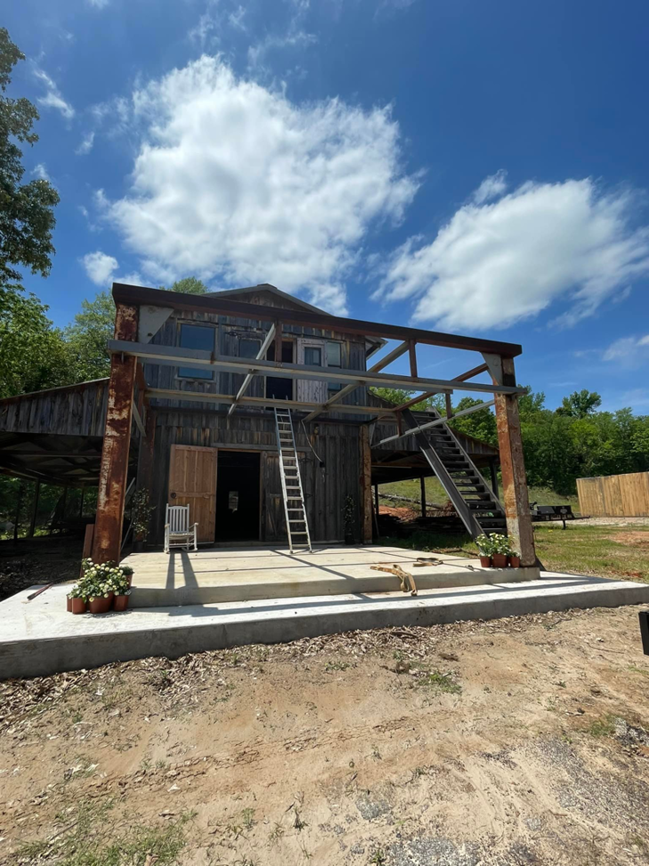 An exterior view of a building under construction with a large concrete pad, a project by SJ Construction Services LLC in Austin, TX.