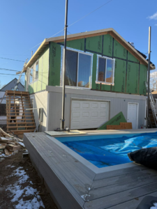 Exterior building construction with new siding and windows by Alex Home Pro Colorado, a handyman in Denver, CO.