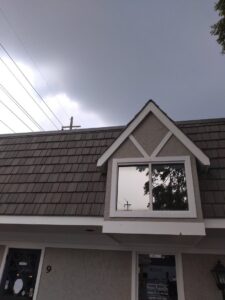 The exterior of a building featuring a newly constructed dormer window by Unique Construction Services in Knoxville, TN