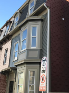 The exterior of a building showcasing new siding and trim work by D'Costa Finish Painting in Fall River, MA.
