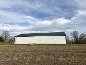 Exterior painting and maintenance of a large metal building by Extreme Precision Painting in Elizabethtown, KY.