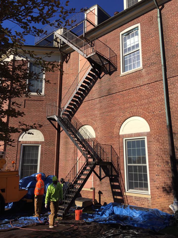 Workers at an exterior building restoration site by Top Notch Sandblasting LLC in Randallstown, MD