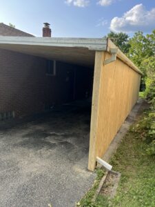Exterior view of a carport renovation with new plywood siding by Jarrett's Home Improvements & Maintenance Services in Columbus, OH