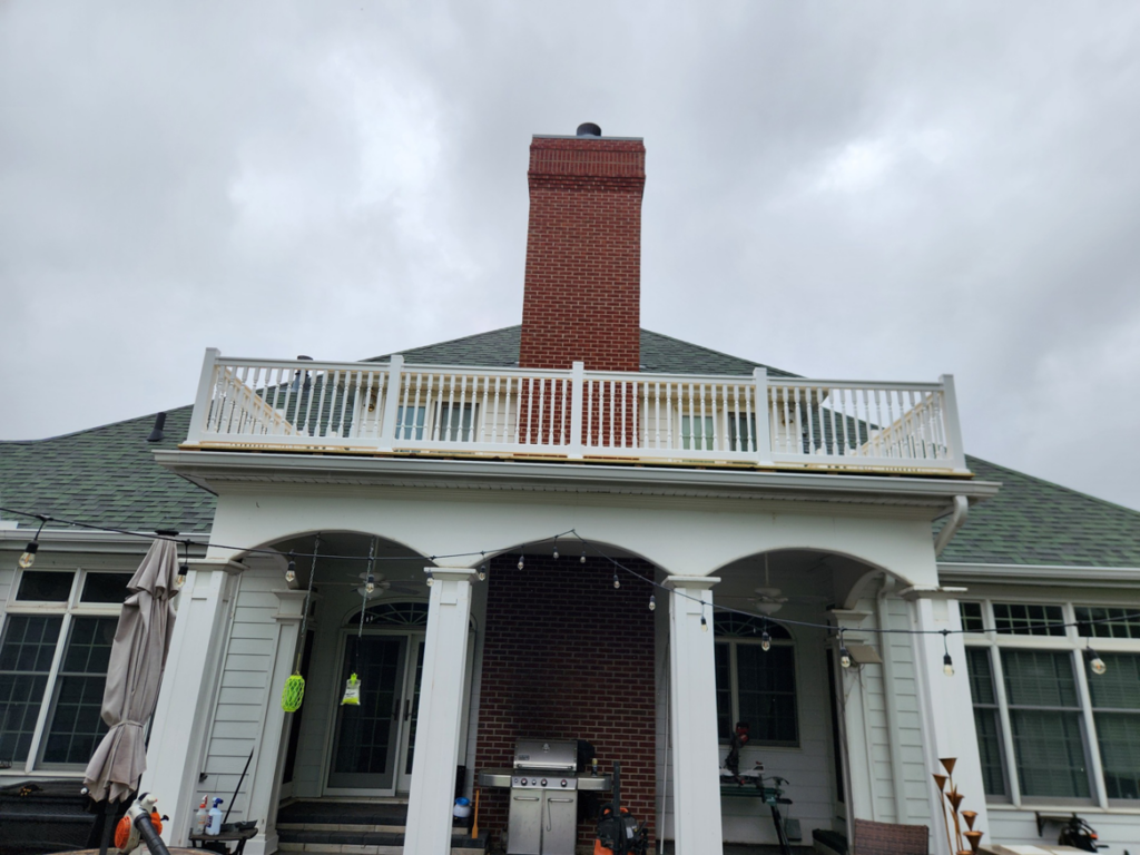 Newly constructed exterior deck or balcony with white railings by SG Service, LLC in Lincoln, NE