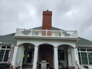 Newly constructed exterior deck or balcony with white railings by SG Service, LLC in Lincoln, NE