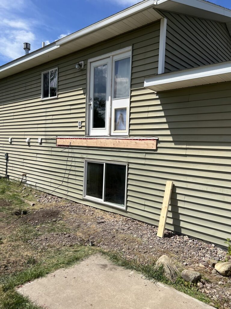 Exterior house view with a new wooden deck or platform under construction by 1775 Handyman Services in Kalispell, MT.