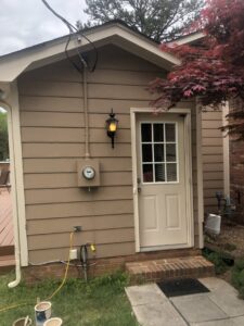 Exterior door and light fixture installation with paint cans visible by Lee's Painting in Northbrook, IL