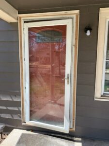An exterior door frame undergoing installation or repair, showing exposed wood, by AON Construction and Remodeling LLC in Wichita, KS.