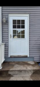 A newly installed white exterior door with glass panels by Class General Contracting in West Springfield, MA.