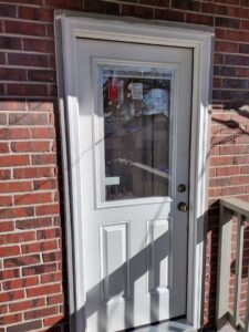 Newly installed exterior door with a glass panel by Colorado Window Solutions in Denver, CO.