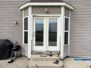 Exterior view of a house with a door installation in progress by Silhouette Builders, Inc. in Yorkville, IL