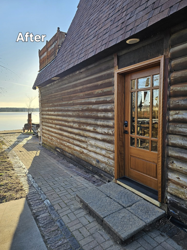 A newly installed exterior wooden door on a log cabin after replacement by All Trades Home Improvement in Hobart, IN.