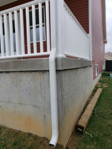 Exterior view of a house with a newly installed downspout by Detweiler Construction, LLC in Horse Cave, KY.