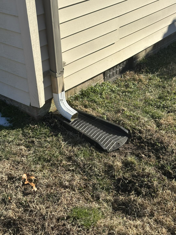 An exterior drainage system installed next to a house by Jps handyman services,inc in Hampton, VA.