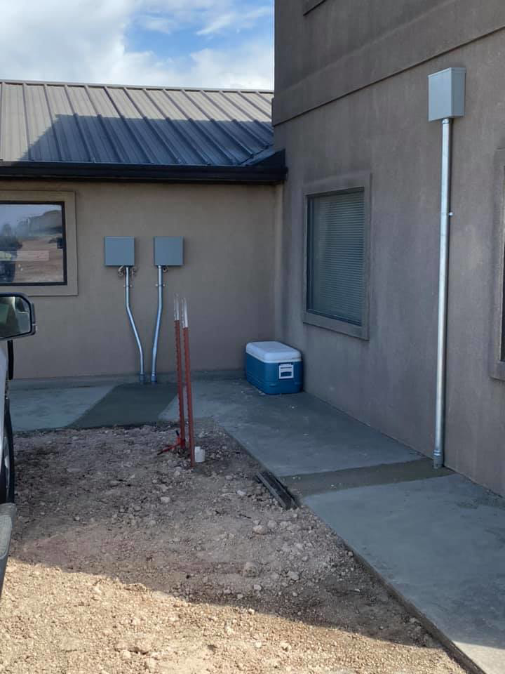 Exterior electrical conduit installation on a building by Harvey's Electric in Perryton, TX