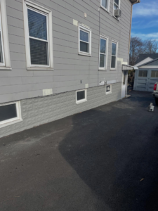 Completed exterior foundation coating and repair by Calnan Site Development LLC in Lynn, MA.