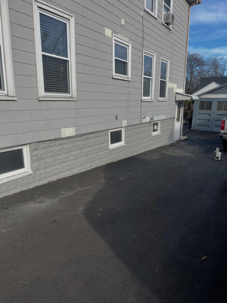 Completed exterior foundation coating and repair by Calnan Site Development LLC in Lynn, MA.