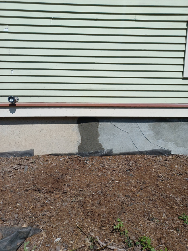 Exterior foundation repair and patching on a house by Clifton Jones Handyman service in South Elgin, IL